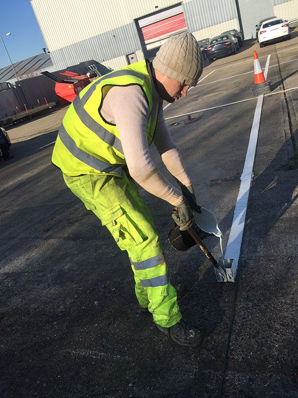 Car park line marking crew painting bay lines in Leatherhead